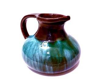 Studio art pottery small handled piece. Glossy brown and greenish blue.
