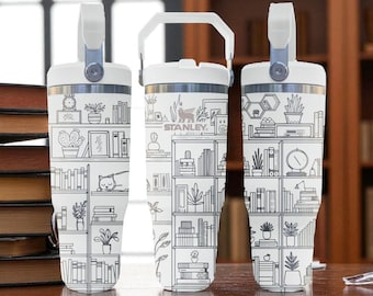 May include: Three white stainless steel tumblers with a black line art print of bookshelves, potted plants, and a sleeping cat. Each tumbler features a white lid with a handle and the Stanley logo printed on the center unit's upper section.