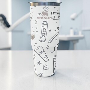 May include: A set of three ceramic mugs with a speckled, matte finish. The mugs are in shades of cream, light gray, and dark gray. Each mug has a simple, minimalist design, perfect for coffee or tea.