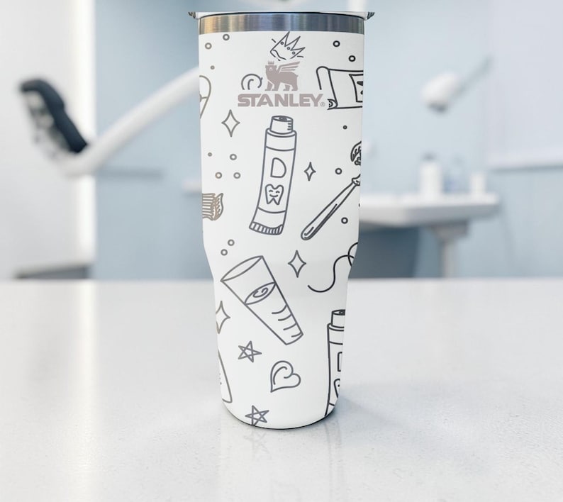 May include: A set of three ceramic mugs with a speckled, matte finish. The mugs are in shades of cream, light gray, and dark gray. Each mug has a simple, minimalist design, perfect for coffee or tea.