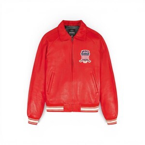May include: A vibrant red leather jacket with a classic bomber style. Features a zip-up front, a collar, and a patch on the chest with the text "AVIREX" and a patriotic design. The cuffs and hem have white and red striped detailing.