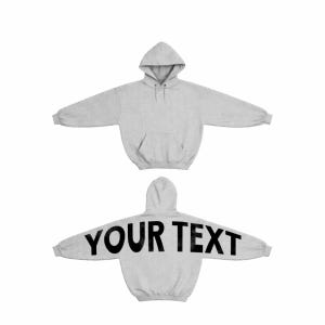 May include: A light grey hoodie with a front kangaroo pocket and a hood. The back of the hoodie displays the text "YOUR TEXT" in large, bold, black letters. The sleeves are long and extend outwards.