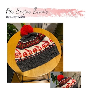 May include: A red and black knitted beanie with a red pom pom on top. The beanie has a pattern of red fire trucks on a white background. The text "Fire Engine Beanie by Lucy Ward" is visible at the top of the image.
