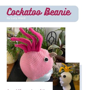 May include: A pink and white crocheted beanie hat shaped like a cockatoo. The hat has a pink crest and a white beak. The hat is on a mannequin head.