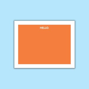 May include: A rectangular orange card with a white border. The word HELLO. is printed in white, sans-serif capital letters at the top center of the orange field. The card is presented against a solid light blue background.