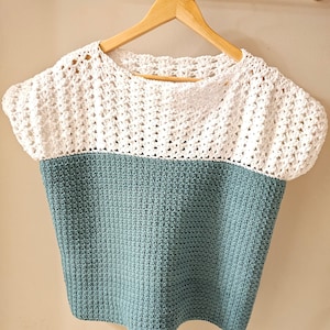 May include: A crocheted top with a white crocheted top and a teal crocheted bottom.