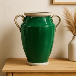 May include: A vibrant green ceramic vase, 45 cm tall, with two curved handles and a cream-coloured rim and base. The vase is displayed on a wooden table. The background is neutral.