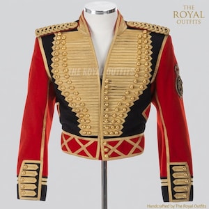 May include: A red, black, and gold military-style jacket. The jacket features gold embellishments, including buttons and trim, with red sleeves and a black front. The jacket is displayed on a mannequin. The Royal Outfits is printed on the top right.