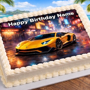 May include: A rectangular cake with white frosting and a printed image of a yellow sports car on a city street. The text "Happy Birthday Name" is displayed above the car. The cake is on a white surface.