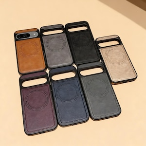 May include: A collection of leather phone cases in various colors, including brown, gray, black, and blue. Each case has a black frame and a circular design on the back. The cases are designed to protect the phone.