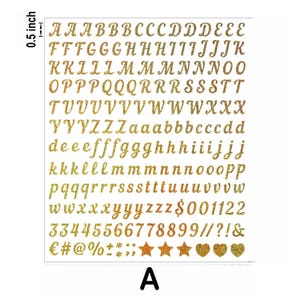 May include: A sheet of gold glitter alphabet stickers, including uppercase and lowercase letters, numbers, and symbols. The sheet measures 0.5 inches in height and features a variety of fonts and sizes. Perfect for scrapbooking and crafting projects.