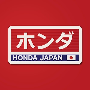May include: A rectangular sticker with a red background and a white border. The sticker features Japanese characters and the words "HONDA JAPAN" in white and blue, with a small Japanese flag.