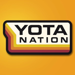May include: A rectangular sticker with the words "YOTA NATION" in bold black letters. The sticker has a cream-colored background with retro orange, yellow, and red stripes. The sticker is outlined in black and set against a yellow-orange background.