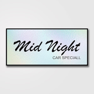 May include: A handmade wooden sign with the text "Welcome to our home" in a handwritten style. The sign is painted white with a dark stained wooden frame. A small green plant is placed on the sign.