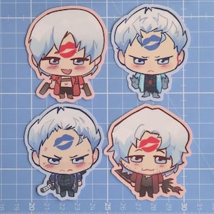 May include: Four chibi-style stickers featuring characters with white hair and various outfits. Each character has a kiss mark on their face. Two stickers have red kiss marks, and two have blue kiss marks. The stickers are on a blue grid background.