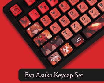 May include: Black keyboard with red keycaps. The keycaps feature anime-style artwork and text. The keyboard has the text "Eva Asuka Keycap Set" on a black banner.