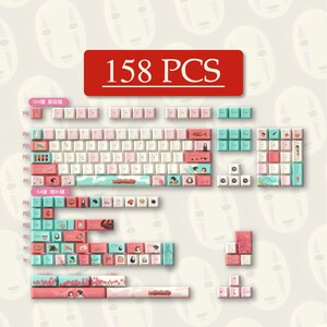 May include: A set of 158 keyboard keycaps in pink, white, and teal. The keycaps feature illustrations and Japanese text. The keycaps are designed for a mechanical keyboard. The text "158 PCS" is in a red rectangle.