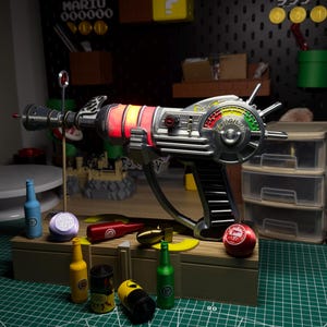 May include: A silver and black ray gun with red and yellow lights, a trigger, and a gauge. The background includes a pegboard with Mario-themed decorations, including the text "MARIO 000000" and "TIME 999". Various miniature bottles and objects are in front of the gun.