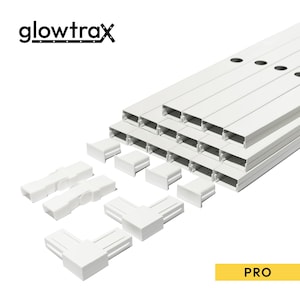 May include: A set of white Glowtrax Pro cable management channels and connectors. The kit includes multiple rectangular plastic tracks with pre-drilled holes, end caps, straight connectors, and corner pieces for organizing electrical wires.