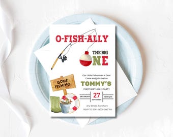May include: A birthday party invitation with a fishing theme. The invitation features the text "O-FISH-ALLY THE BIG ONE" in red and green. It includes a fishing rod, bobber, and a sign that says "GONE FISHING". The invitation is for Tommy's first birthday.