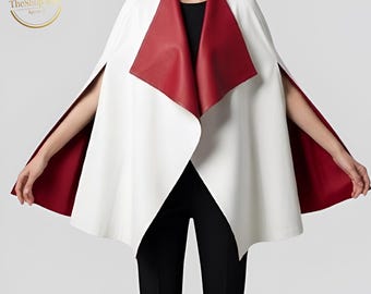 May include: A white cape with a red collar and interior lining. The cape has a flowing design and is worn over a black top and pants. The Shop & Apparel logo is in the upper left corner.