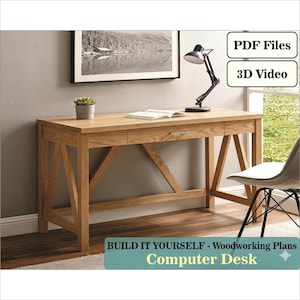 May include: A light-colored wooden computer desk with two drawers and a cross-braced leg design. A black desk lamp, a small potted plant, and an open book sit on the desk. The text "PDF Files" and "3D Video" are in the upper right corner. The text "BUILD IT YOURSELF - Woodworking Plans Computer Desk" is at the bottom.