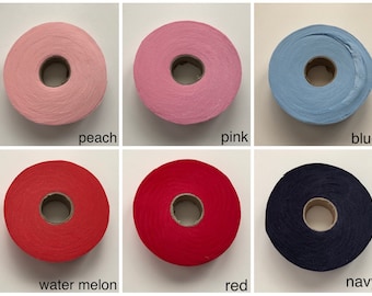May include: Six spools of yarn in different colors: peach, pink, blue, water melon, red, and navy.