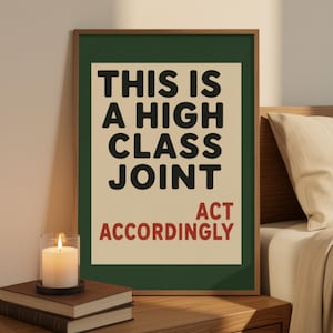 May include: A rectangular wall art print in a thin wooden frame featuring a dark green border and a cream-colored center. The text reads THIS IS A HIGH CLASS JOINT in black, with the words ACT ACCORDINGLY printed in red at the bottom right.