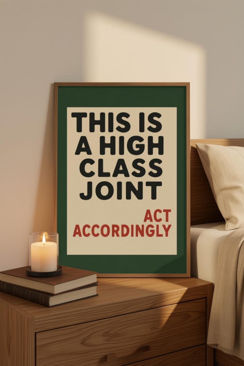May include: A rectangular wall art print in a thin wooden frame featuring a dark green border and a cream-colored center. The text reads THIS IS A HIGH CLASS JOINT in black, with the words ACT ACCORDINGLY printed in red at the bottom right.