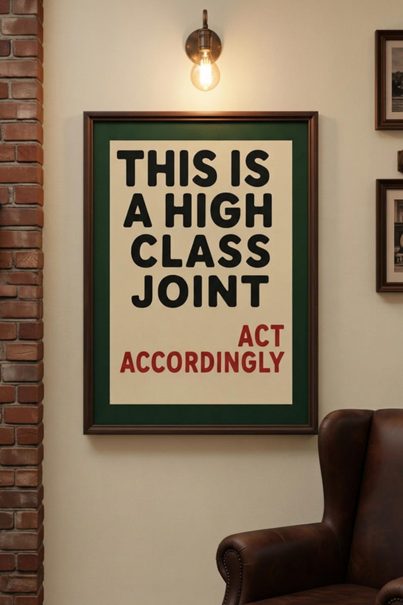 May include: A rectangular framed wall art piece featuring a cream-colored background with bold black text that reads THIS IS A HIGH CLASS JOINT and red text below that reads ACT ACCORDINGLY. The print is enclosed in a dark brown wooden frame.