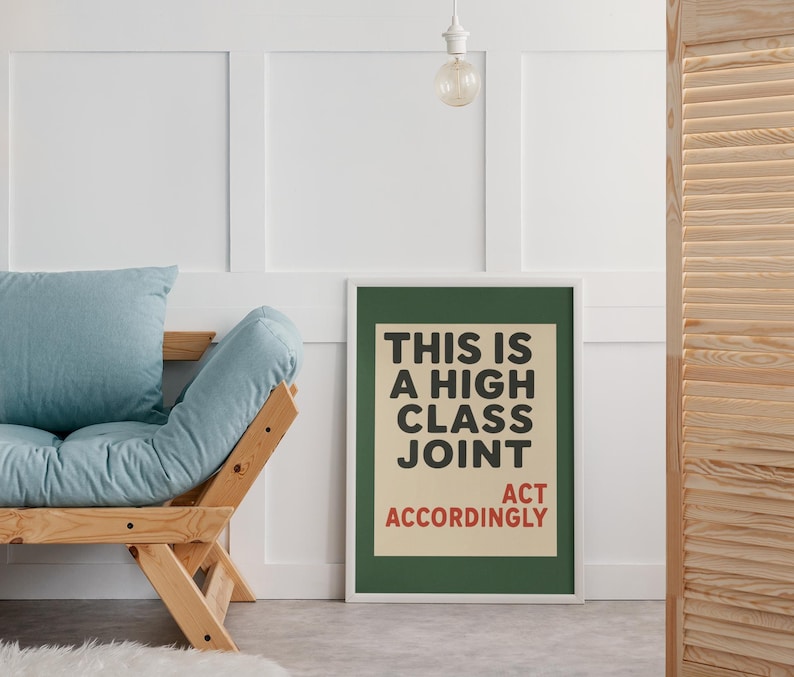 May include: A rectangular framed wall art print featuring a dark green border and a cream-colored center panel. The text reads THIS IS A HIGH CLASS JOINT in bold black letters, with the words ACT ACCORDINGLY printed in red at the bottom.