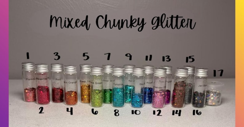 May include: A collection of seventeen small, clear glass vials filled with various colors of chunky glitter, arranged in a row. Each vial is topped with a silver screw cap and labeled with a number from 1 to 17. The text Mixed Chunky glitter is visible.