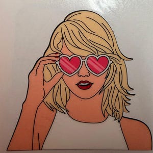 May include: A graphic illustration of a person with shoulder-length blonde hair wearing heart-shaped sunglasses with pink lenses and white frames. The person has red lipstick and is wearing a plain white top, depicted in a clean, comic-book style.