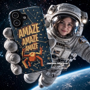 May include: A dark blue smartphone case featuring a constellation pattern, a stylized orange crab illustration, and the repeated yellow text "AMAZE" in a stacked layout. The case includes a camera cutout and is held against a space background.