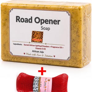 May include: A rectangular bar of Road Opener Soap with a white label and the text "Road Opener Soap". The soap is a light yellow color and is packaged in clear plastic. A red mesh sponge is included.