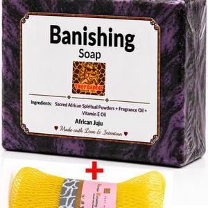 May include: A rectangular bar of "Banishing Soap" with a purple and black marbled design, packaged in clear plastic. The label includes the brand name "Trop Baddie Pour Toi" and ingredients. A yellow exfoliating net sponge is included.