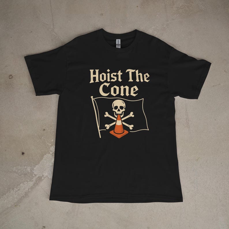 May include: Black t-shirt with the text "Hoist The Cone" above a flag design. The flag features a skull, crossbones, and an orange traffic cone. The shirt is a crew neck style.
