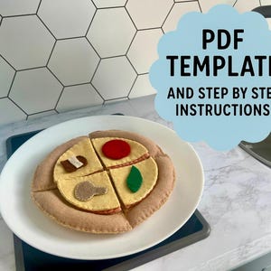 May include: A felt pizza toy with four slices, each topped with different felt ingredients like a mushroom, tomato, and green pepper, presented on a white plate. The image includes text that says "PDF TEMPLATE AND STEP BY STEP INSTRUCTIONS".