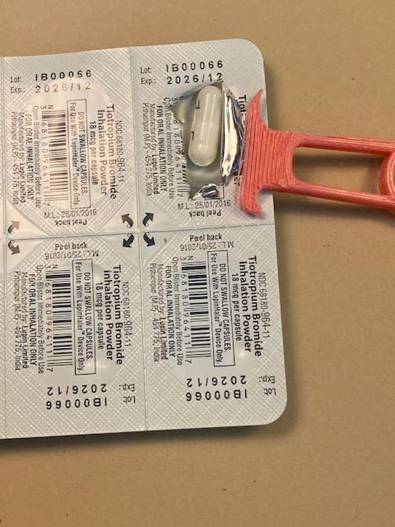 May include: A blister pack of Tiotropium Bromide inhalation powder capsules, 18 mcg per capsule. The expiration date is 2026/12. A red plastic device is partially visible. The capsules are for oral inhalation only.