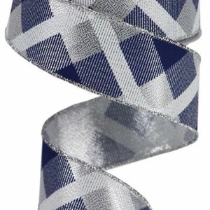 May include: A roll of navy blue and silver chevron patterned ribbon with a wired edge. The ribbon is 2.5 inches wide.