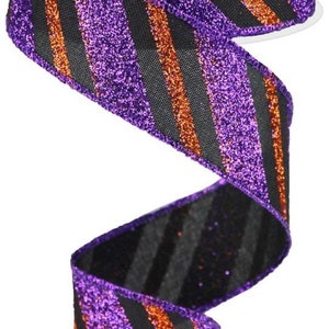 May include: A roll of decorative ribbon with a glittery finish. The ribbon features alternating diagonal stripes of purple, black, and orange. The ribbon is likely used for crafts, gift wrapping, or holiday decorations.