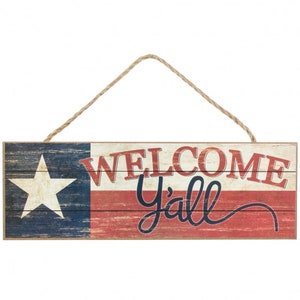 May include: Wooden sign with a distressed, vintage look featuring a Texas flag design and the text "Welcome Y'all" in a black script font.