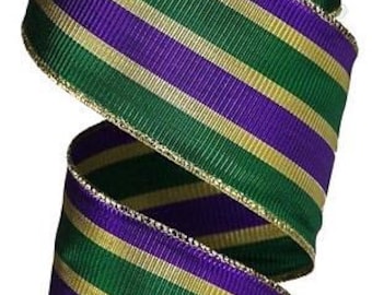 May include: A roll of green, purple, and gold striped ribbon with a gold wired edge. The ribbon is 2.5 inches wide.