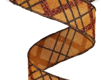 May include: A roll of decorative ribbon with a plaid pattern. The ribbon features a tan background with a dark brown grid design and accents of glittery copper. The ribbon is ideal for gift wrapping, crafting, and seasonal decorations.