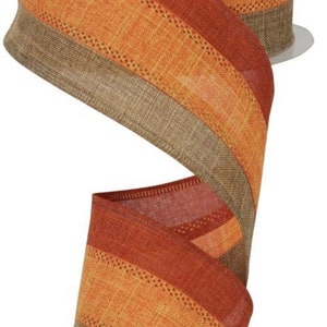 May include: A roll of 2.5 inch wide, brown, orange, and tan striped wired ribbon with a textured woven fabric.