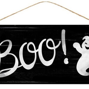 May include: A black wooden sign with a white ghost and the word "BOO!" in white cursive lettering.