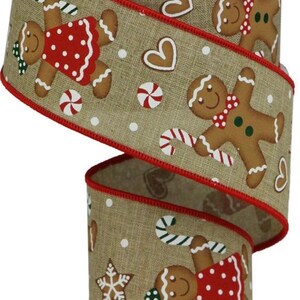 May include: A 2.5 inch wide brown burlap ribbon with a red edge. The ribbon features a repeating pattern of gingerbread people, candy canes, hearts, and stars.