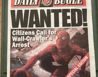 May include: A newspaper front page from the Daily Bugle with the headline "WANTED!" featuring Spider-Man. The paper includes articles about Spidey and Goblin attacks, and a special edition banner.