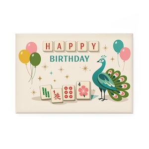 May include: A rectangular birthday card with a peacock illustration. The words "HAPPY BIRTHDAY" are displayed in a playful font. Balloons and Mahjong tiles add to the festive design. The color palette includes teal, pink, yellow, and beige.