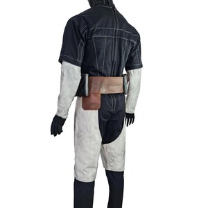 May include: A black and white costume displayed on a mannequin. The outfit includes a short-sleeved black top with white stitching, white and black trousers, a brown belt with pouches, and black gloves. The mannequin has a black head covering.